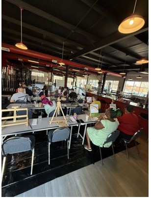 Guests painting together at a Painted Scene party