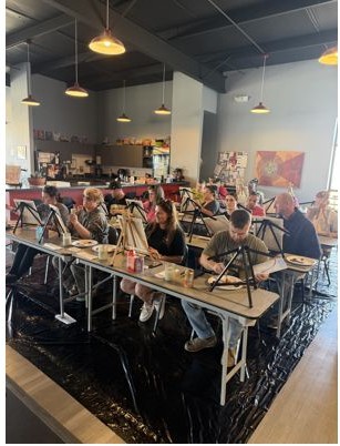 Guests gathered for a Painted Scene paint party