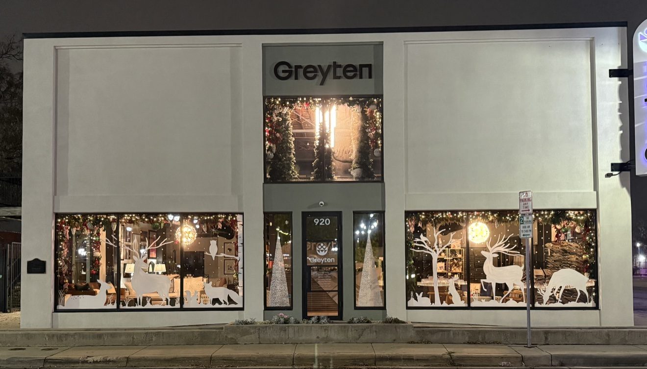 Full storefront with window paintings at night