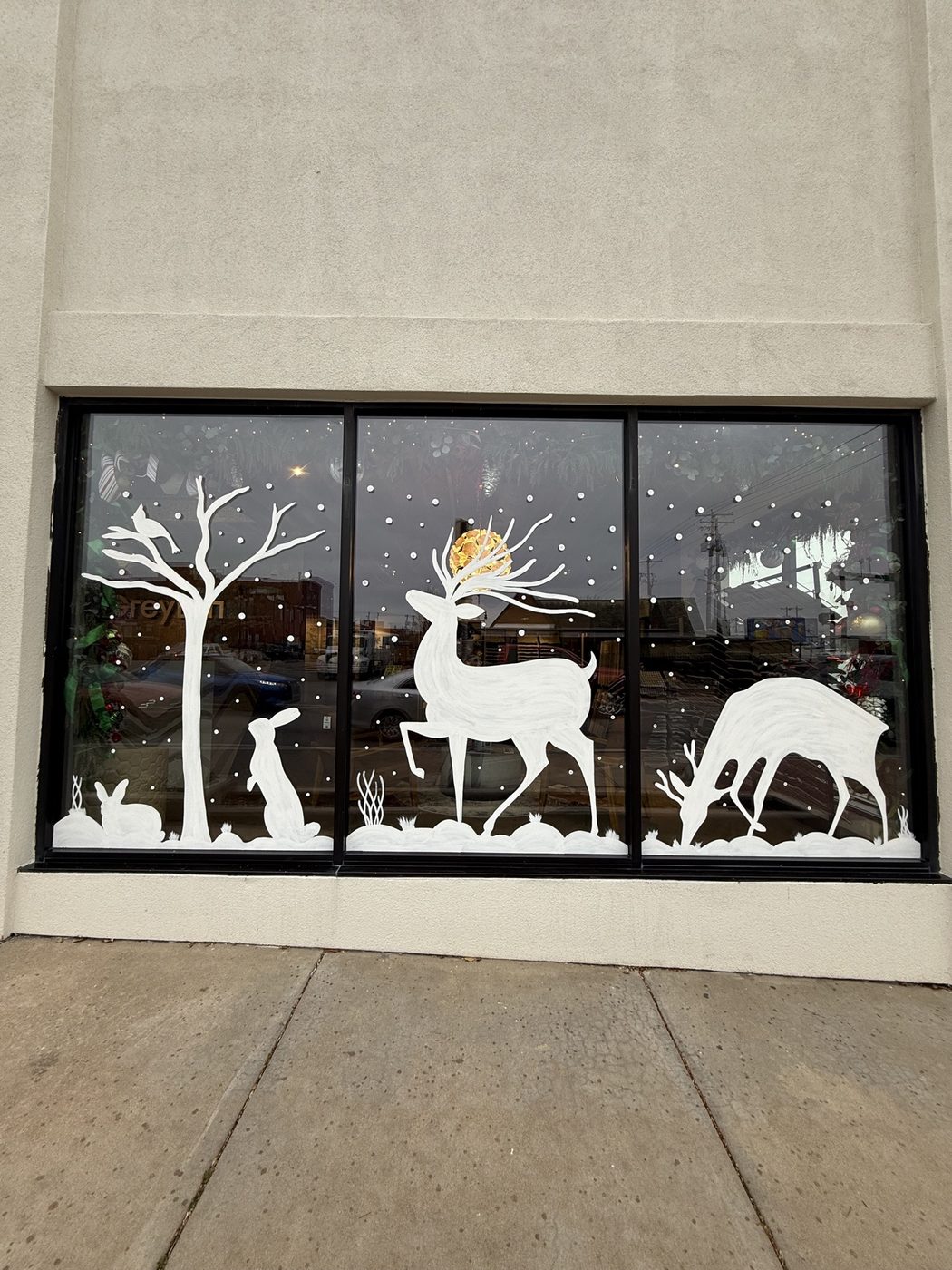 Reindeer, rabbits, and tree window painting in daylight