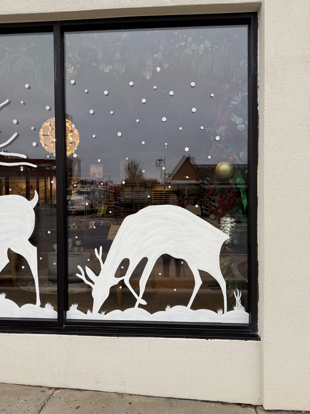 Grazing deer window painting with snowfall
