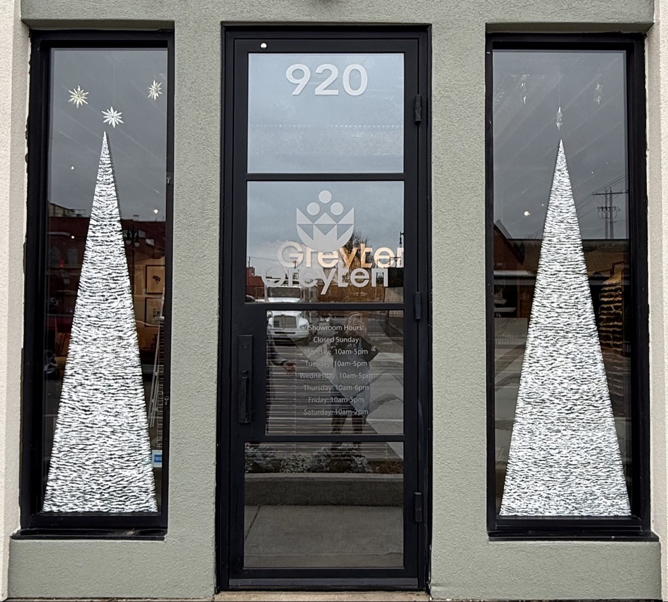 Storefront door with painted trees on each side