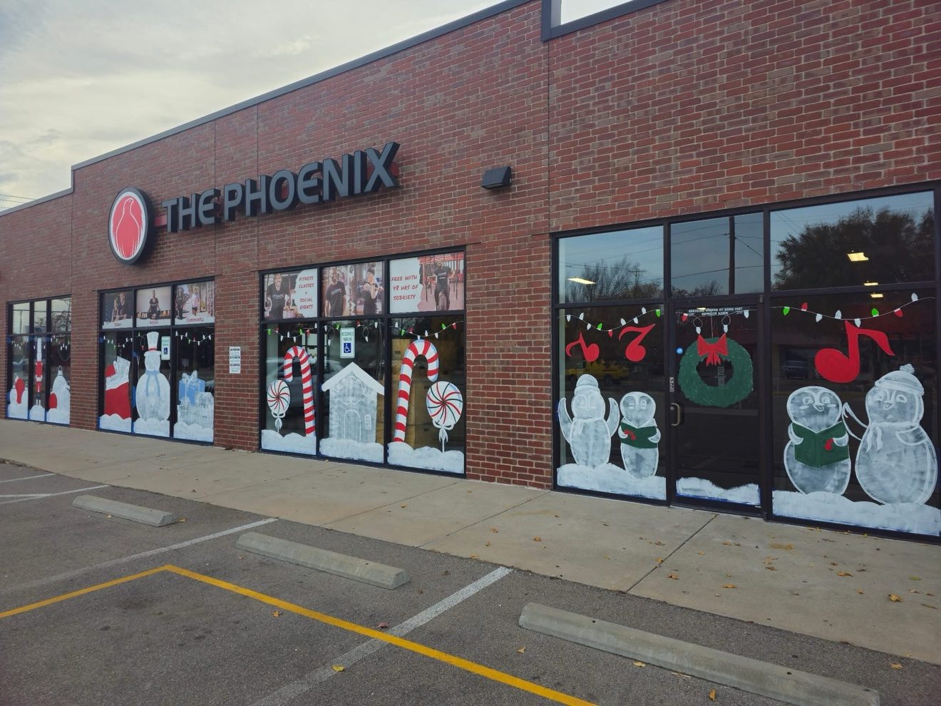 Holiday window paintings across The Phoenix storefront