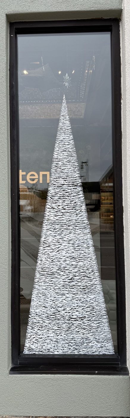 Tall pine tree painted on a door window