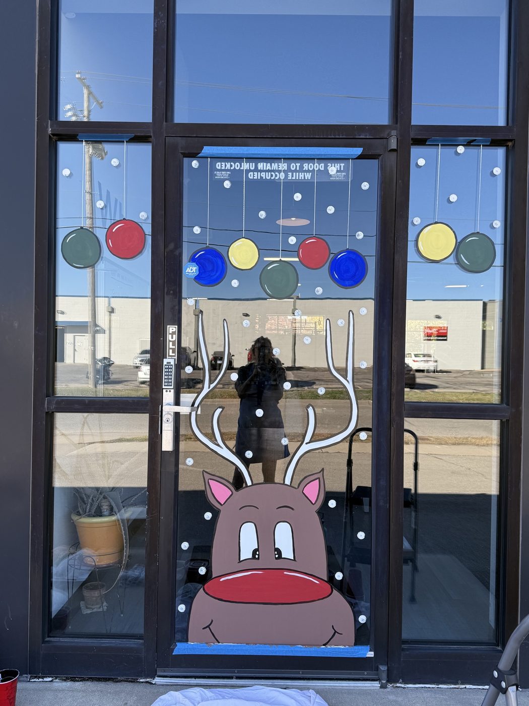 Smiling reindeer window painting with ornaments