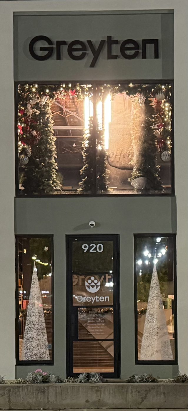 Painted storefront windows glowing at night