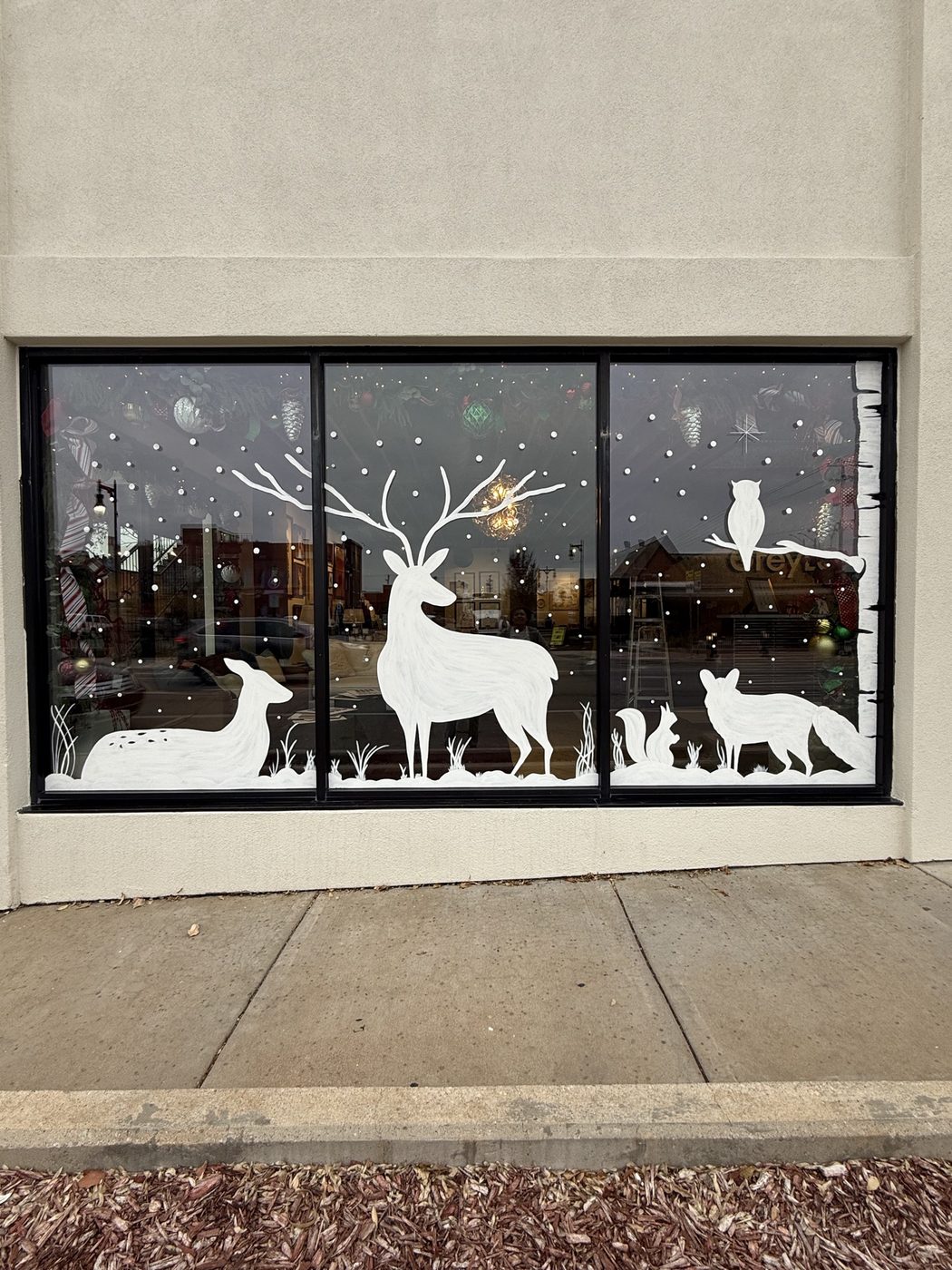 Woodland window painting with deer, owl, fox, and squirrel